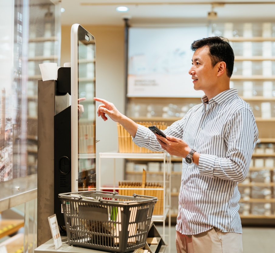 Shopper using a self-checkout kiosk supported by retail IT solutions